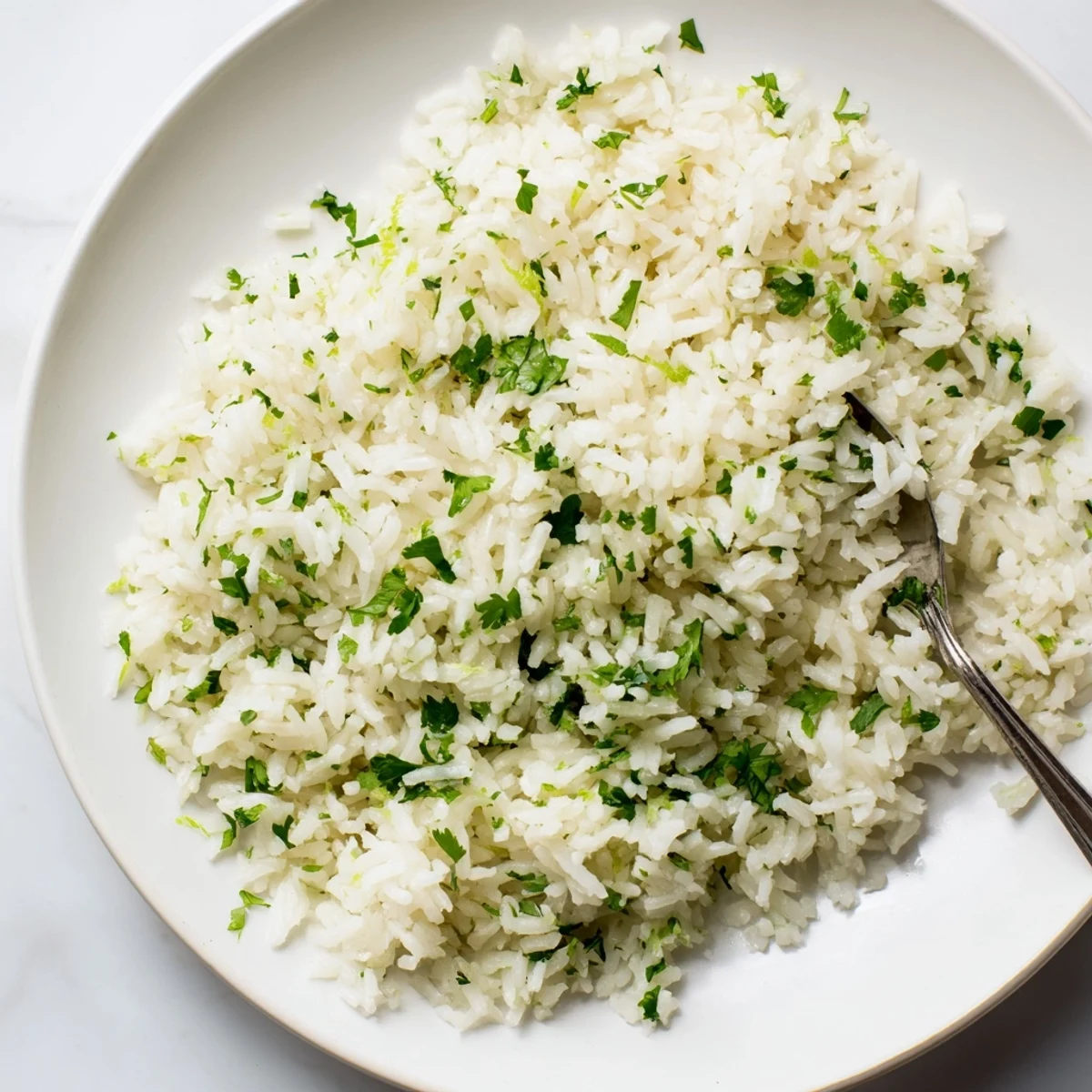 Fluffy cilantro lime rice, bright green with cilantro, is ready to be a side for your tacos.
