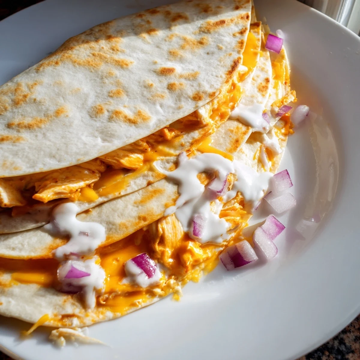 Golden-brown Buffalo Chicken Quesadilla, oozing with melted cheese and ready to serve with ranch.