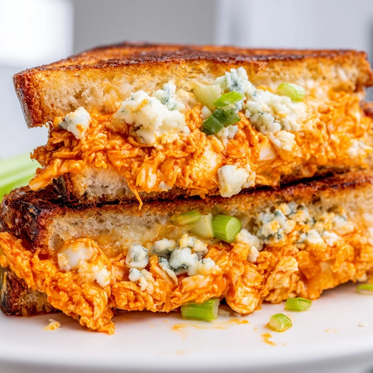 Crispy, golden-brown Buffalo Chicken Grilled Cheese sliced, ready to enjoy for lunch or dinner.