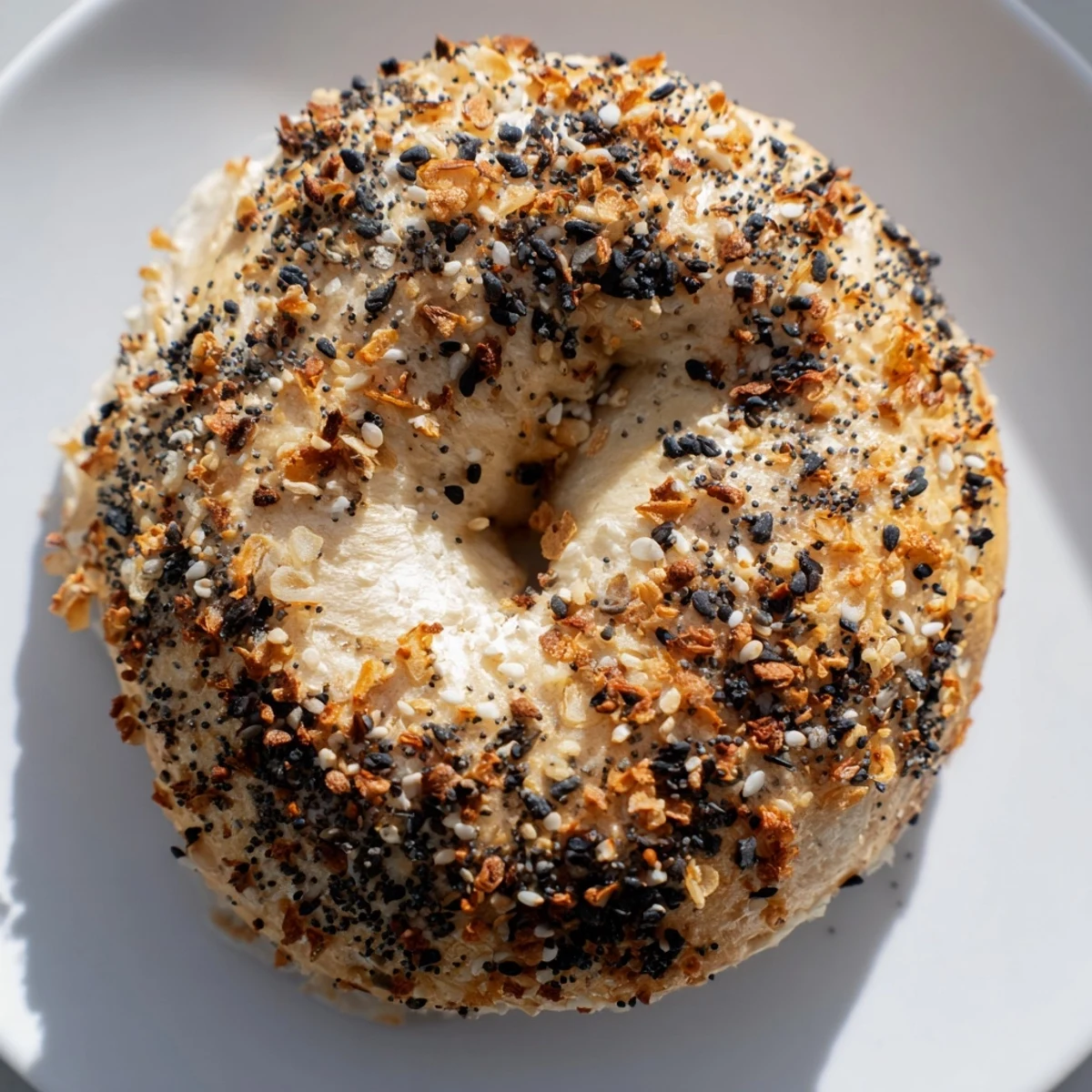 A close-up of delicious Everything Bagel Yogurt Bagels, showing the golden crust and enticing seasoning.