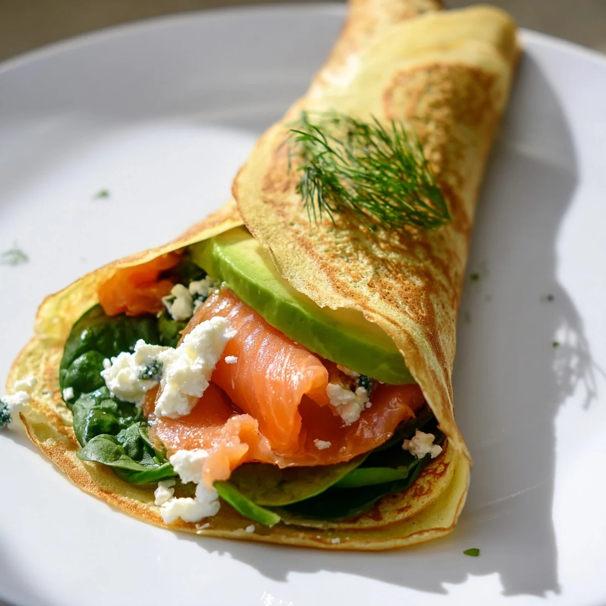 Fluffy blender egg crepe wrap, rolled up with savory fillings; ready for a delicious breakfast.