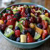 Colorful fruit display with edible flowers, creating a stunning centerpiece for graduation events.
