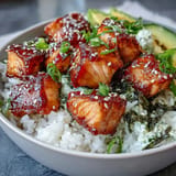 Vibrant spicy mayo salmon rice bowl with crisp cucumber and toasted sesame seeds, ready in minutes.