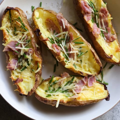 Golden, cheesy Crispy Air-Fryer Potato Skins topped with bacon, sour cream, and fresh chives.