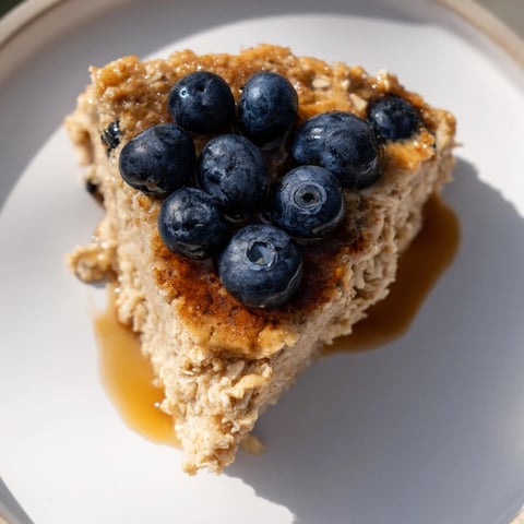 Warm Protein Pancake Oats, fluffy and golden, ready to be sliced and served with fruit.