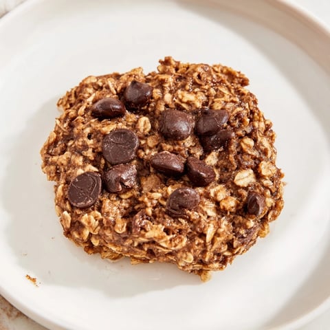 Warm, soft chocolate oatmeal breakfast cookie, boasting melty chocolate chips and a delightful oat texture.