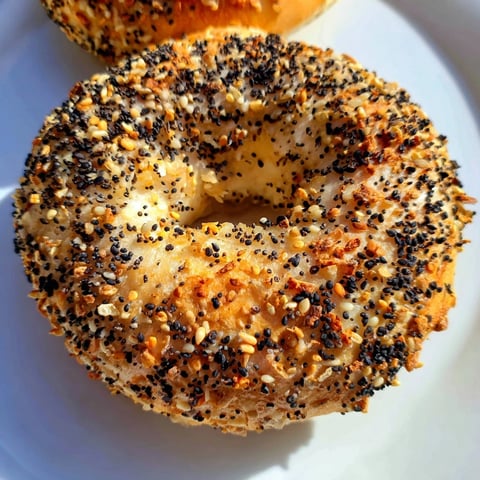 Golden-brown Everything Bagel Yogurt Bagels, fresh from the oven, with a generous topping of savory seasoning.