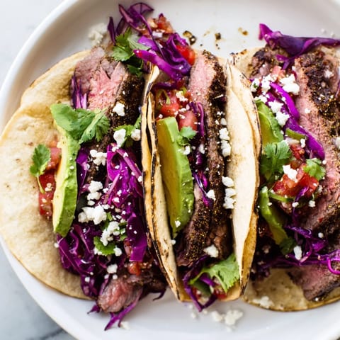 Grilled Coffee-Rubbed Steak Tacos, showcasing tender, juicy steak with colorful toppings like avocado and cilantro.