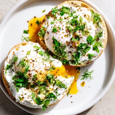 Enjoy the beautiful layers of this Çılbır Eggs Benedict, featuring golden yolks and toasted muffins.