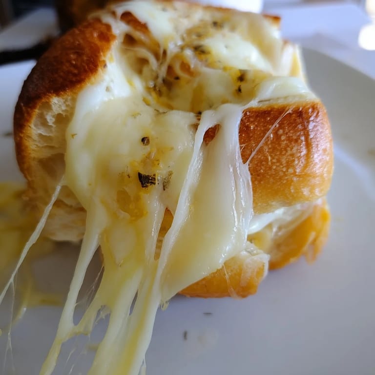 Thick, buttery sourdough bread encasing layers of sharp cheddar, provolone, and melty mozzarella in this Triple Cheese Sourdough Grilled Cheese.