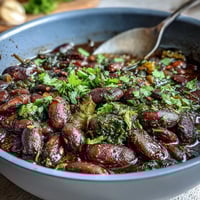 Hearty soul food black-eyed pea and collard green stew with smoky, earthy flavors in a comforting Southern bowl.