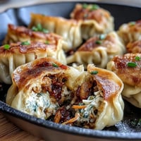 Golden, pan-fried edges on crispy cabbage dumplings, perfect with dipping sauce.
