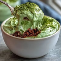 Vibrant Matcha Tiramisu boasting creamy swirls and a dusting of green powder.